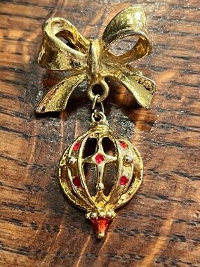Gold-Tone Bow Brooch with Red-Accent Hanging Ornament